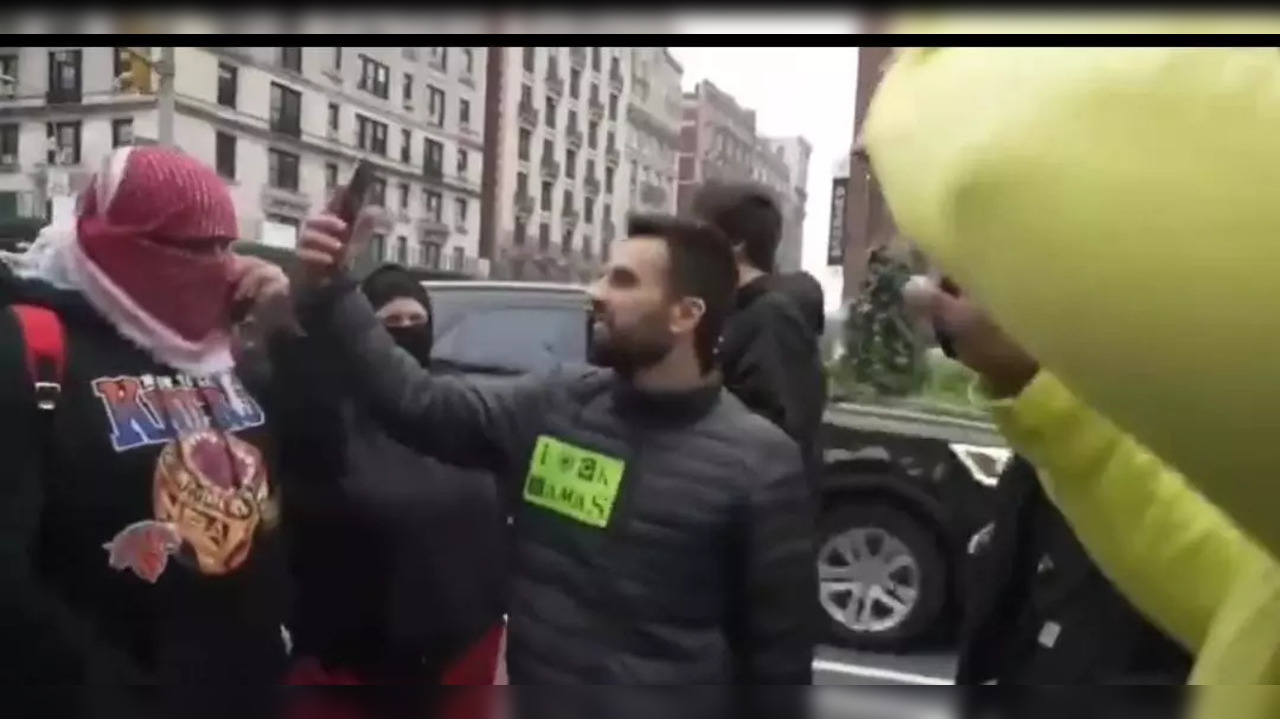 Yoseph Haddad (Center) Moments Before Masked Person (L) Assaulted Him