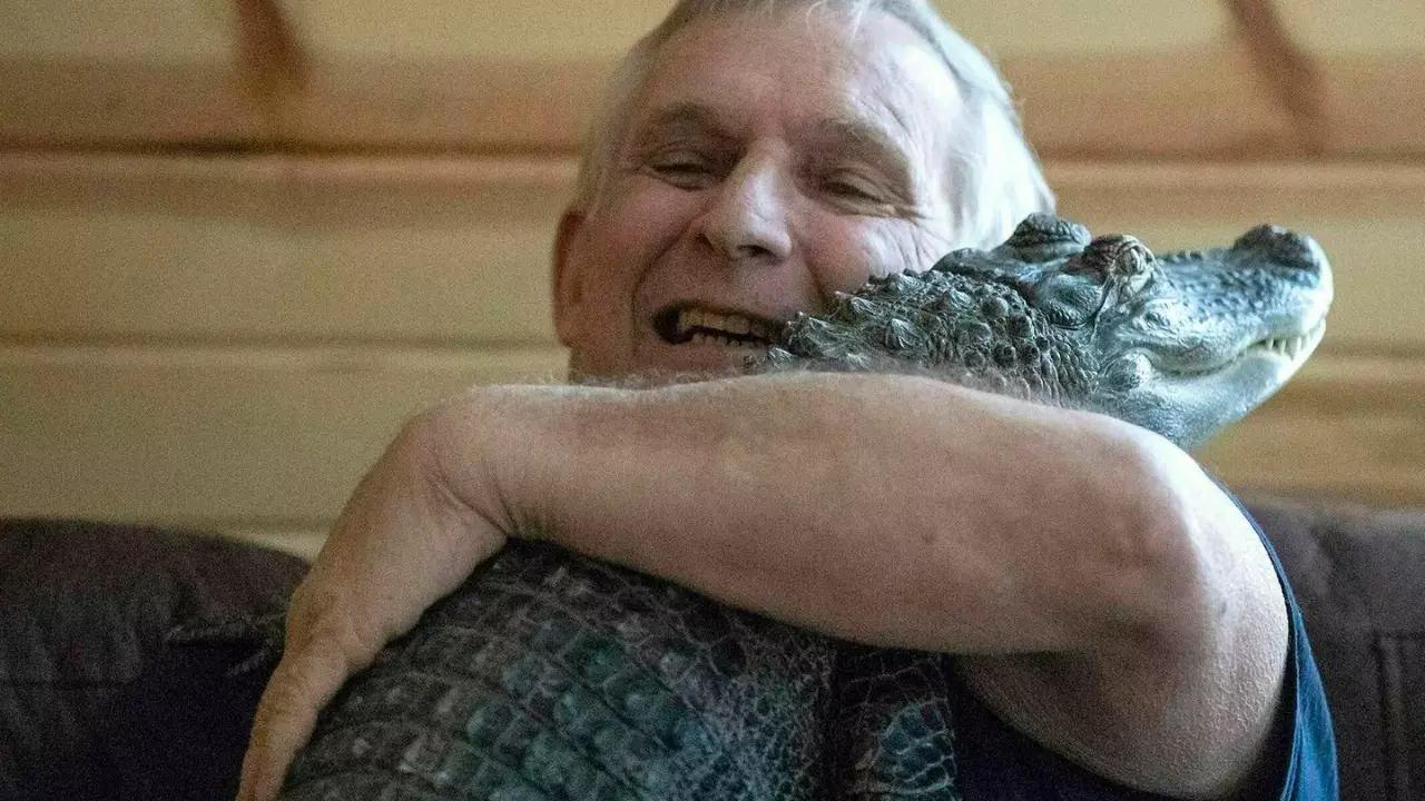 Joie Henney pictured with Wally, his emotional support alligator. | Courtesy: AP