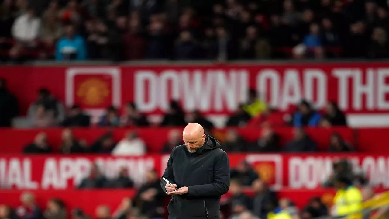 Manchester United manager Erik ten Hag takes note during a game