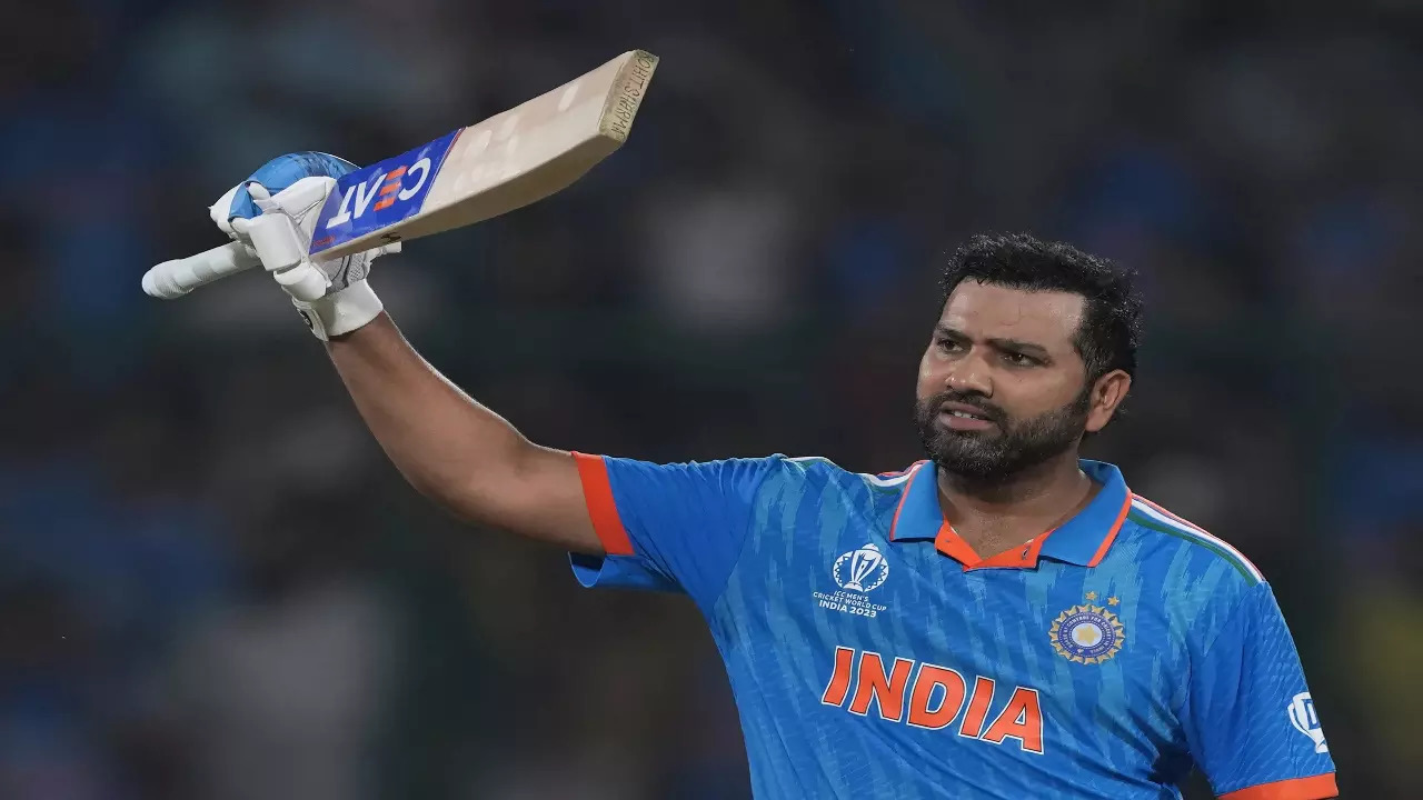 Rohit Sharma raises his bat against Afghanistan in the ODI World Cup