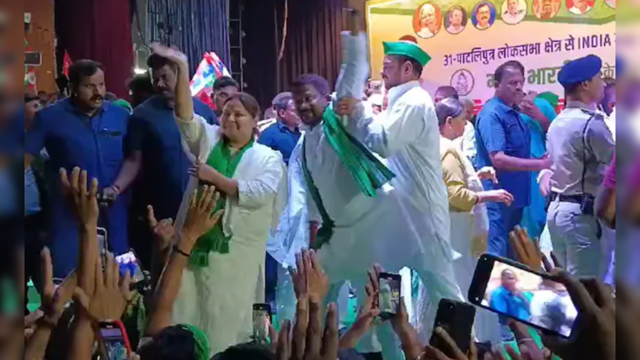 Tej Pratap Yadav pushes a party worker off the stage