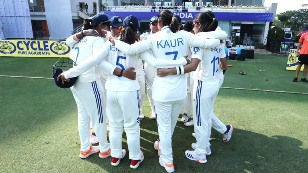Indian women's cricket team in a huddle during a Test match