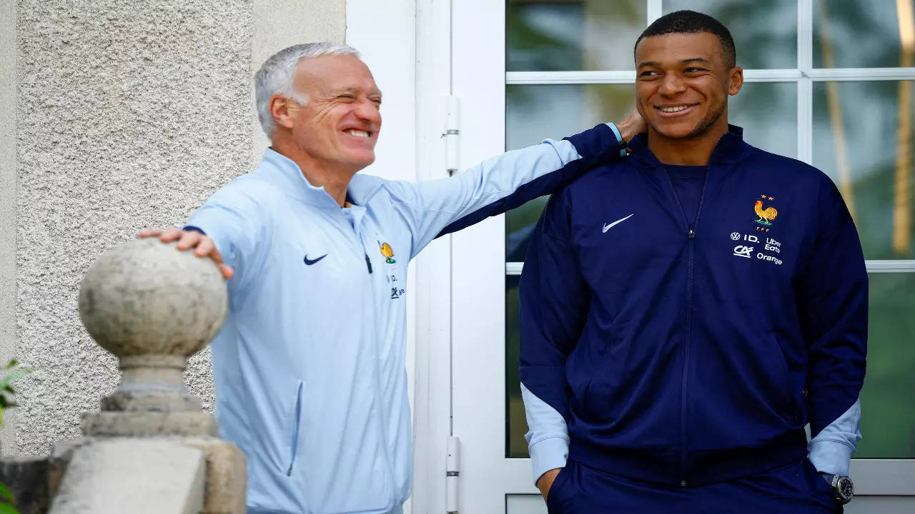 Kylian Mbappe shares a light moment with Didier Deschamps