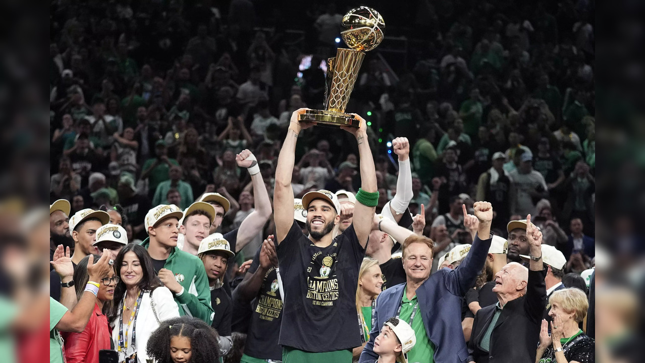 Jayson Tatum with the NBA trophy