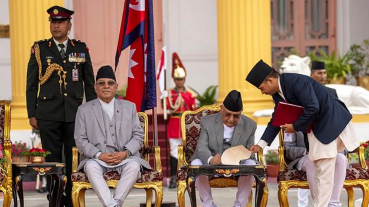 Newly elected Prime Minister KP Sharma Oli signs documents after he was sworn by President Ram Prassad Poudel at the Presidential residence in Kathmandu, Nepal, Monday, July 15.