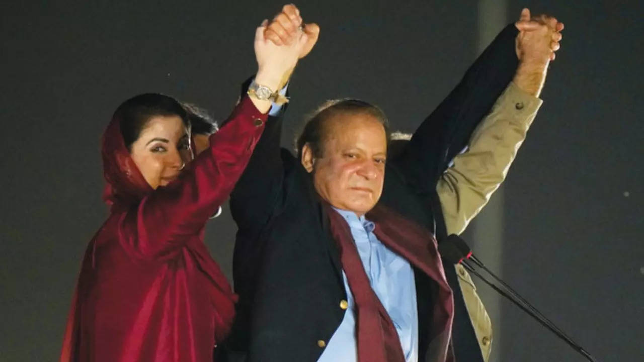 Nawaz Sharif, with his daughter Maryam Nawaz, wave to his supporters upon his arrival to address a welcoming rally, in Lahore. ​