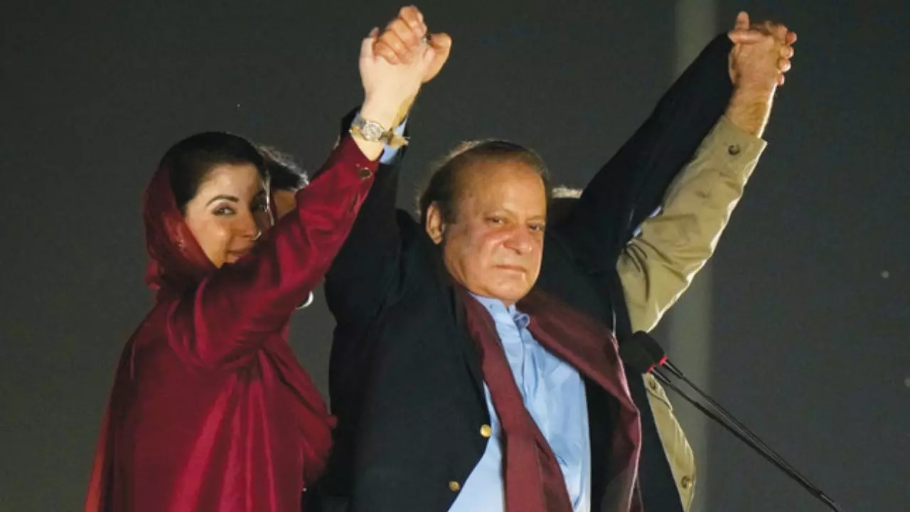 Nawaz Sharif, with his daughter Maryam Nawaz, wave to his supporters upon his arrival to address a welcoming rally, in Lahore. ?