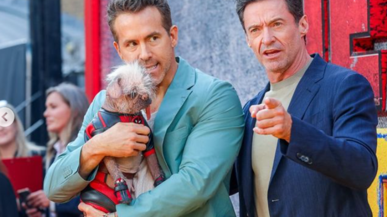 Ryan Reynolds and Hugh Jackman pose with Peggy the dog