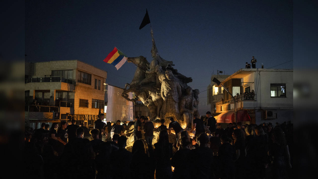 People light candles in memory of those killed in rocket strike