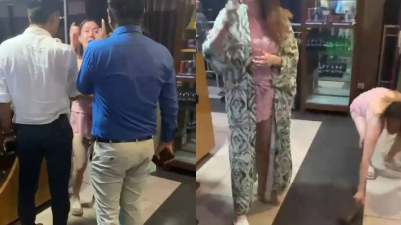 video: foreign woman throws shoe at officials who raided illegal business being run as spa in ahmedabad