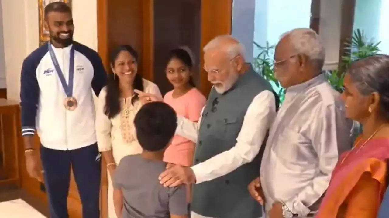 PM Narendra Modi during his meeting with PR Sreejesh and his family.