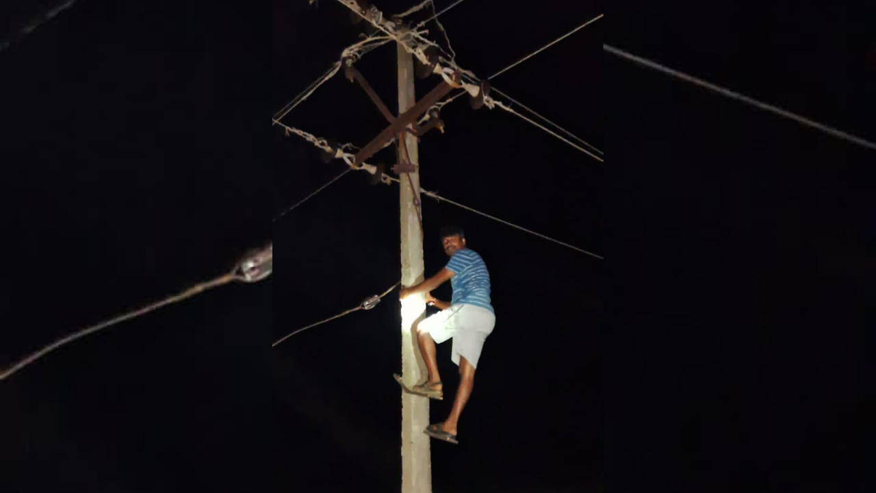 fed up of long power cut, telangana man climbs electricity pole - video