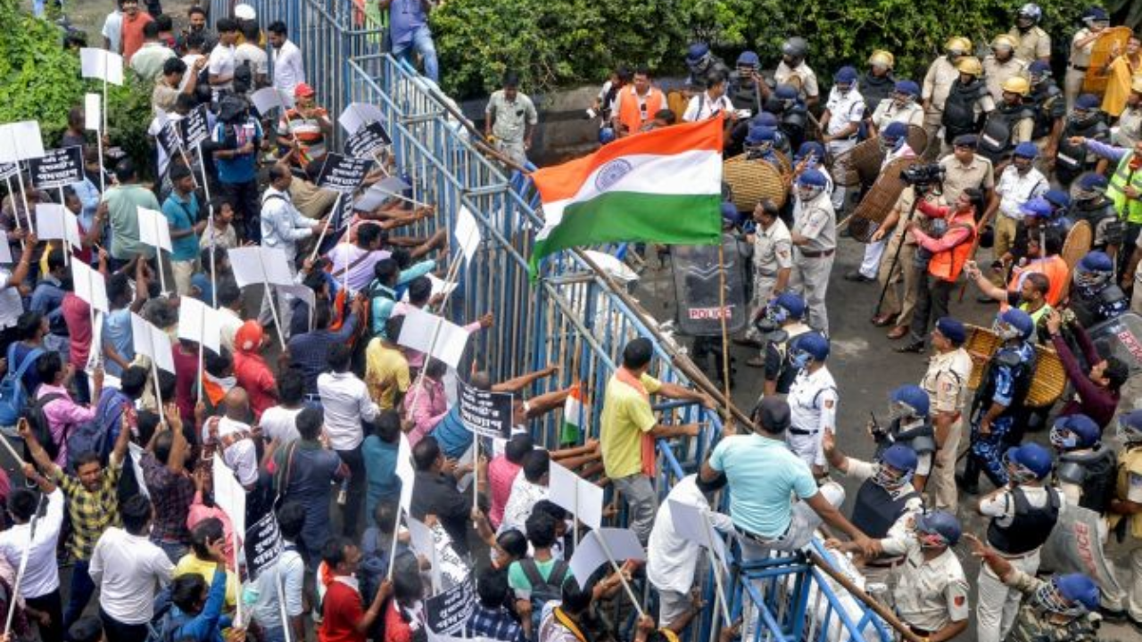 Protesters try to climb over barricades during march on Tuesday