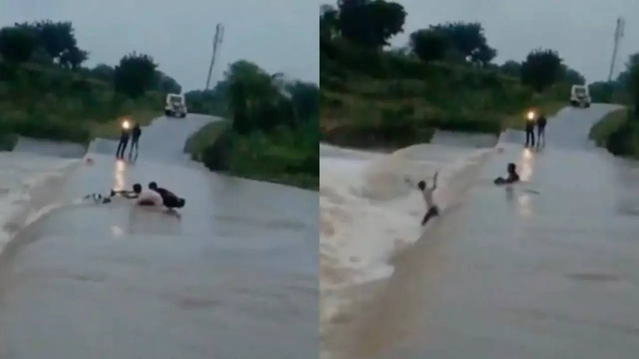 Men jump in an overflowing stream to save their bike in Ashnoknagar, MP. | Credit: Social media