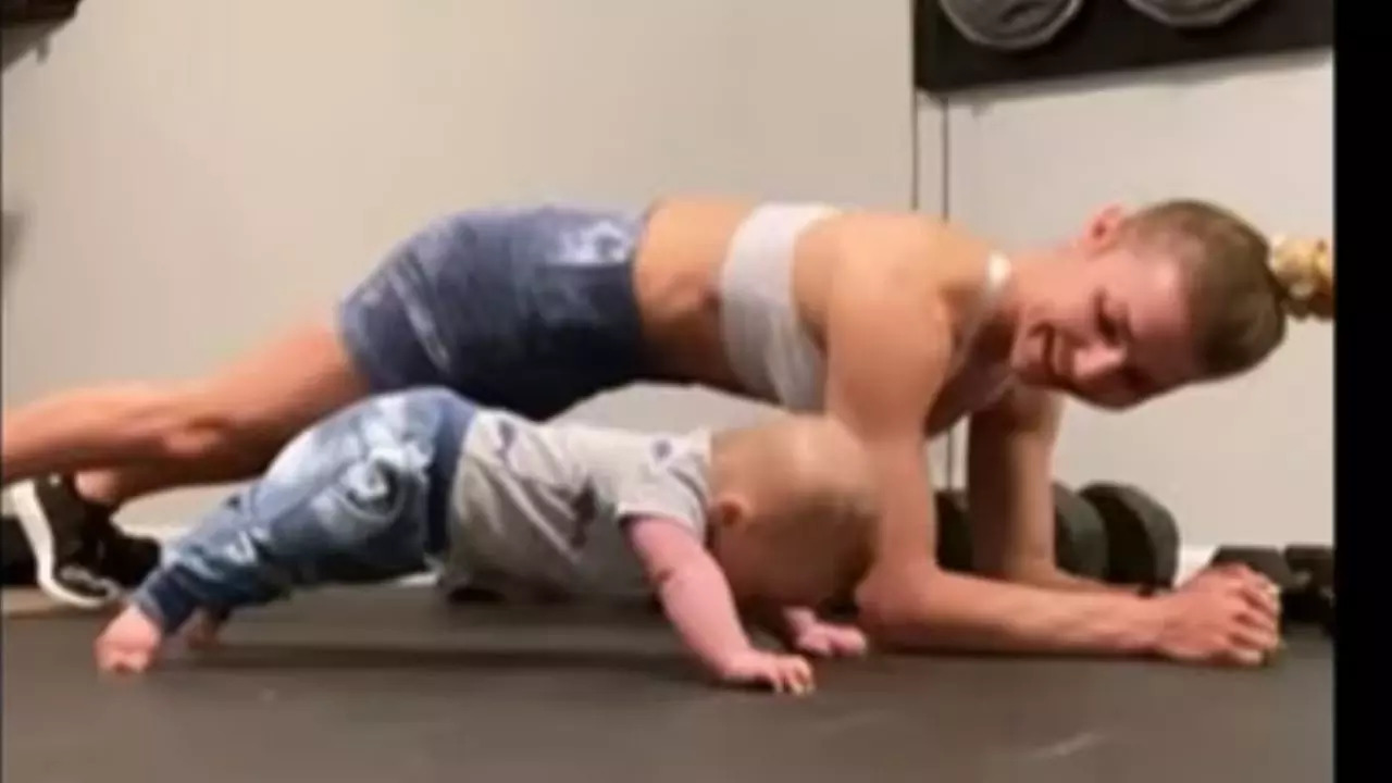 The baby works out with his mother.