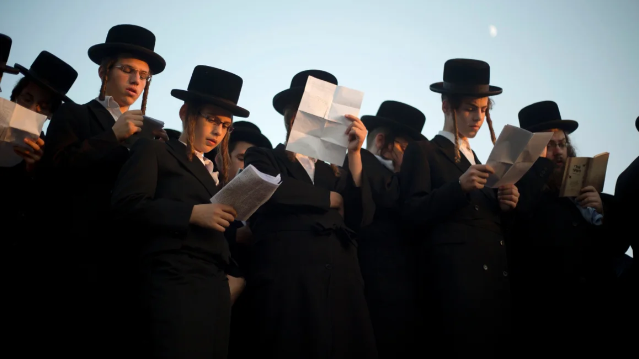 Jews pray on the Hayarkon river banks as they participate in a Tashlich ceremony in the Israeli town of Ramat Gan near Tel Aviv