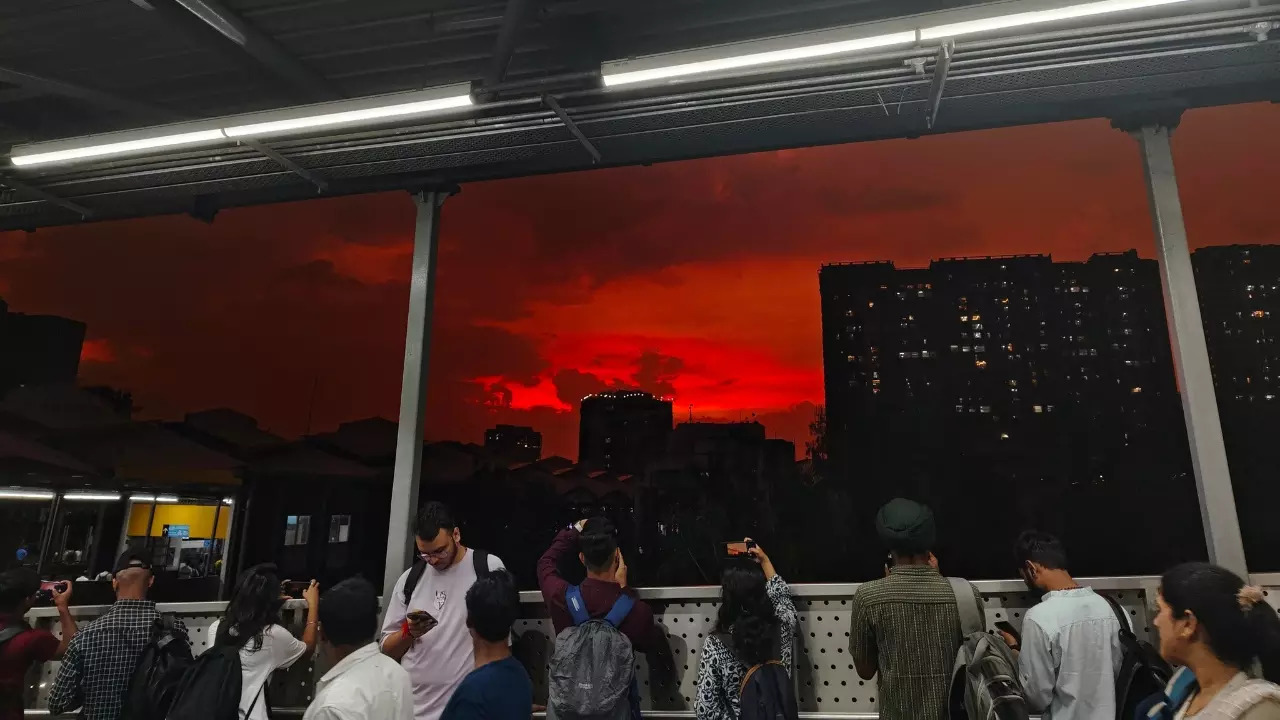 Commuters at DN Nagar Metro Station, Andheri, stop to take pictures of the sunset. | Arsenic Humour