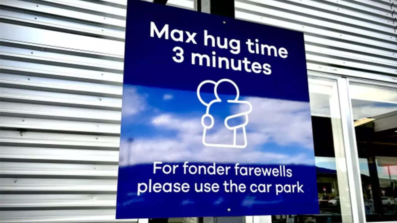 'Max hug time 3 minutes,' reads a sign at Dunedin Airport, New Zealand. | Courtesy: Dan De Bono