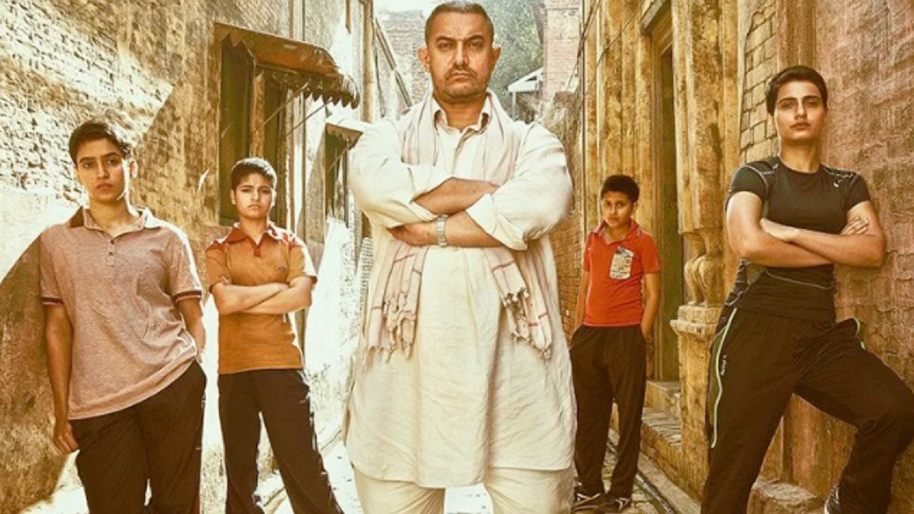 Aamir Khan with his onscreen daughters in Dangal.