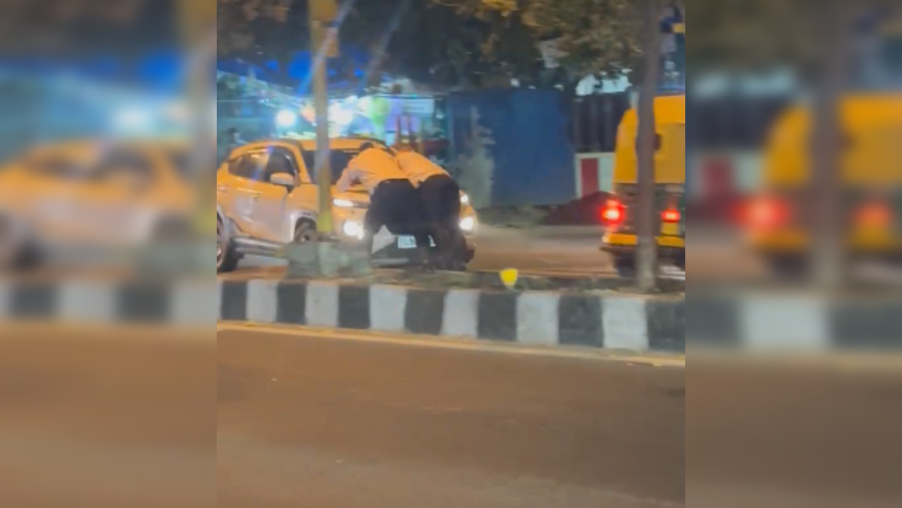 Delhi cop on car bonnet