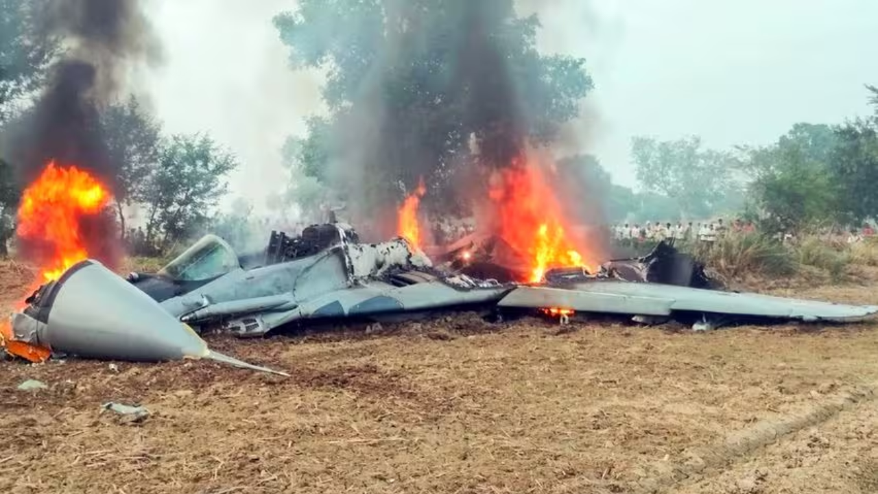 Flames and smoke billow out from the wrecked remains of IAF's MiG 29 fighter jet that crashed near Agra