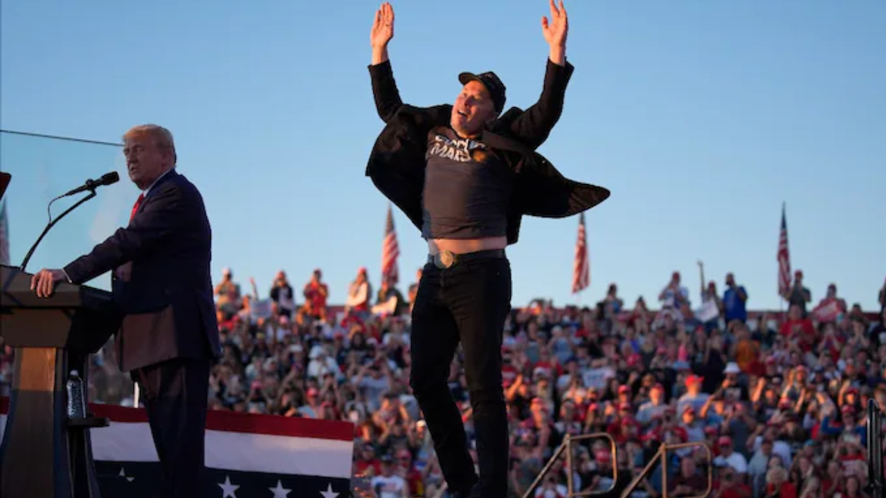 Elon Musk jumps on the stage as Republican presidential nominee Donald Trump speaks at a campaign rally in Butler, Pennsylvania.