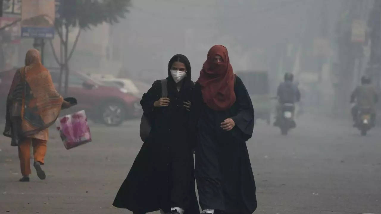 Students wear mask and heading to their school as smog envelops the areas of Lahore, Pakistan