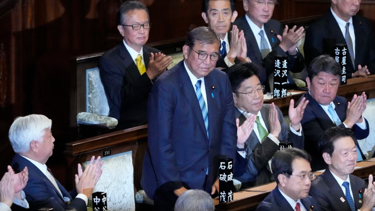 Lawmakers applaud as prime minister Shigeru Ishiba, standing, is re-elected