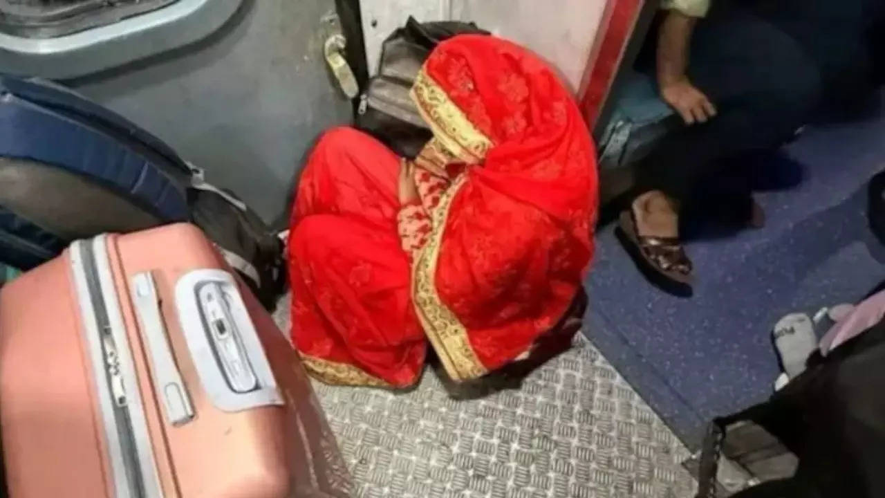 A viral photo of a bride sitting on train floor has sparked a debate online