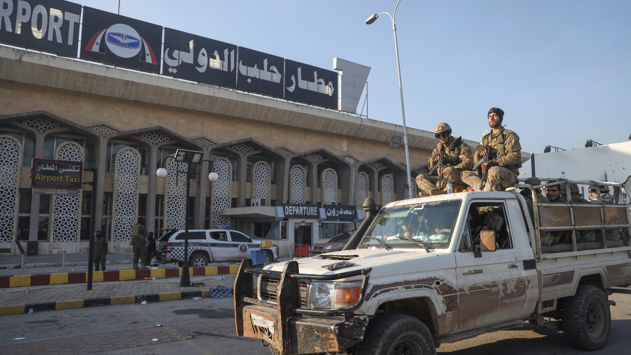 Syrian opposition fighters ride in Aleppo