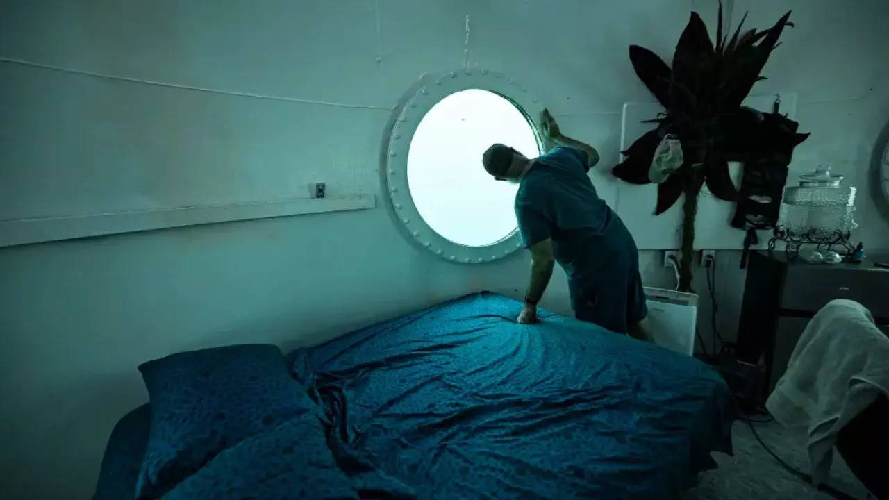 Rudiger Koch looking through his window in his underwater living space. (AFP)