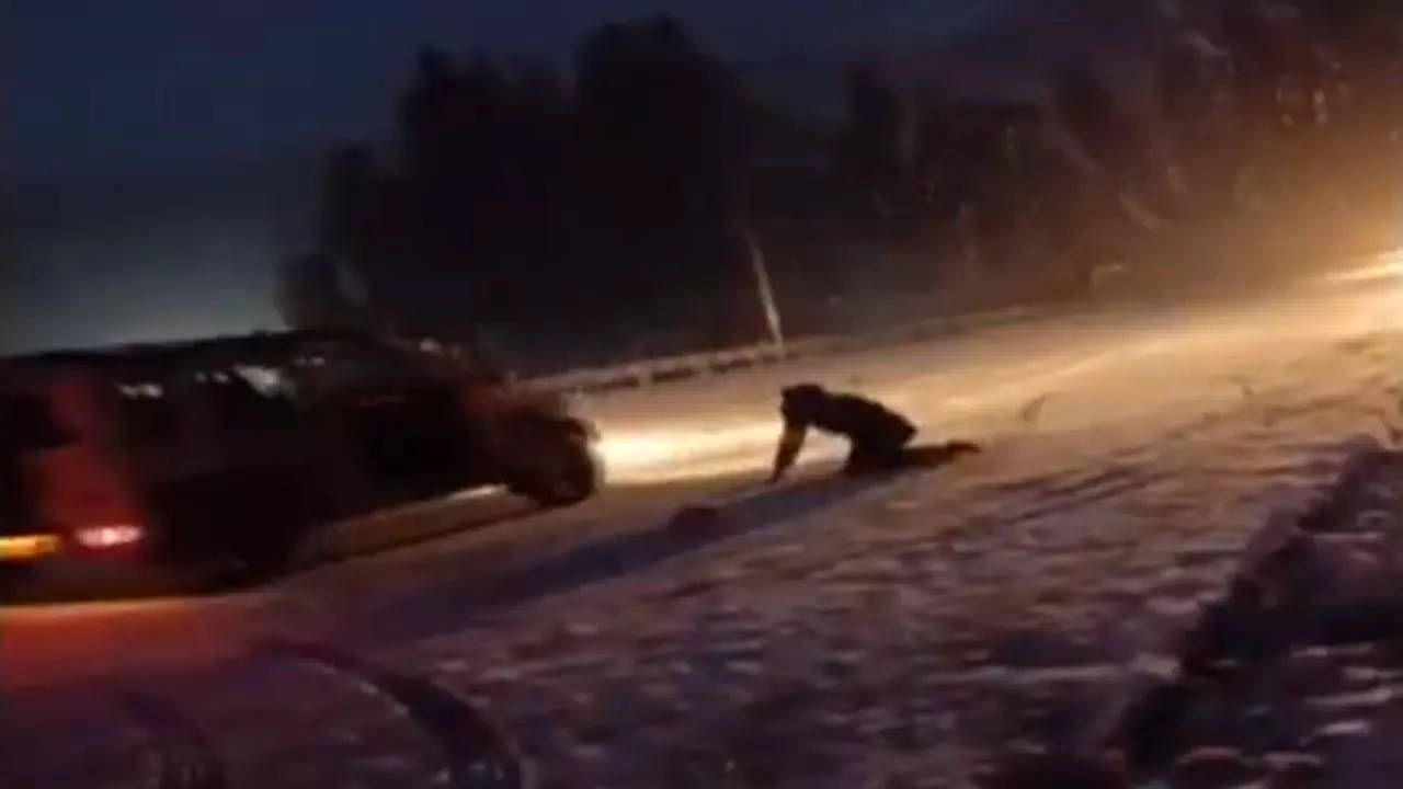 Screen grab showing driver of a car on the road as it starts sliding backwards