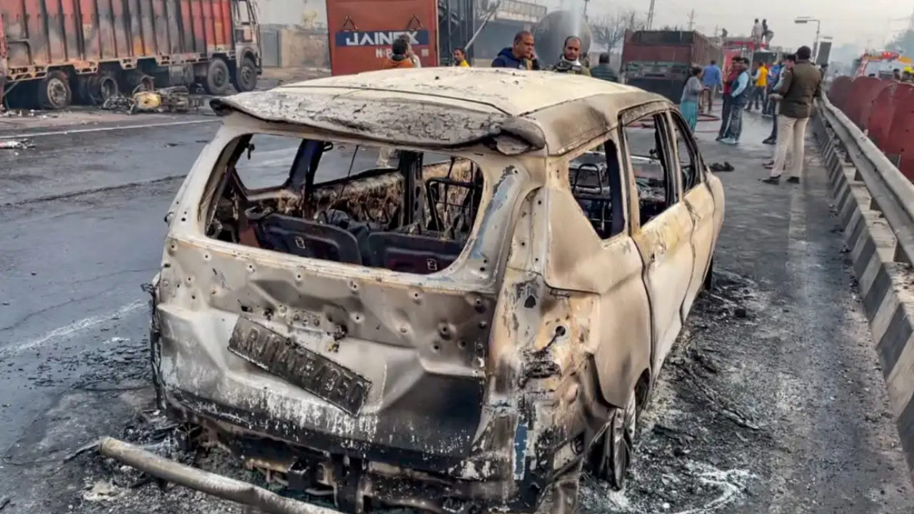 A charred vehicle at the site of the accident after a truck loaded with a chemical collided with some other vehicles and caught fire on the Jaipur-Ajmer Highway, in Jaipur.