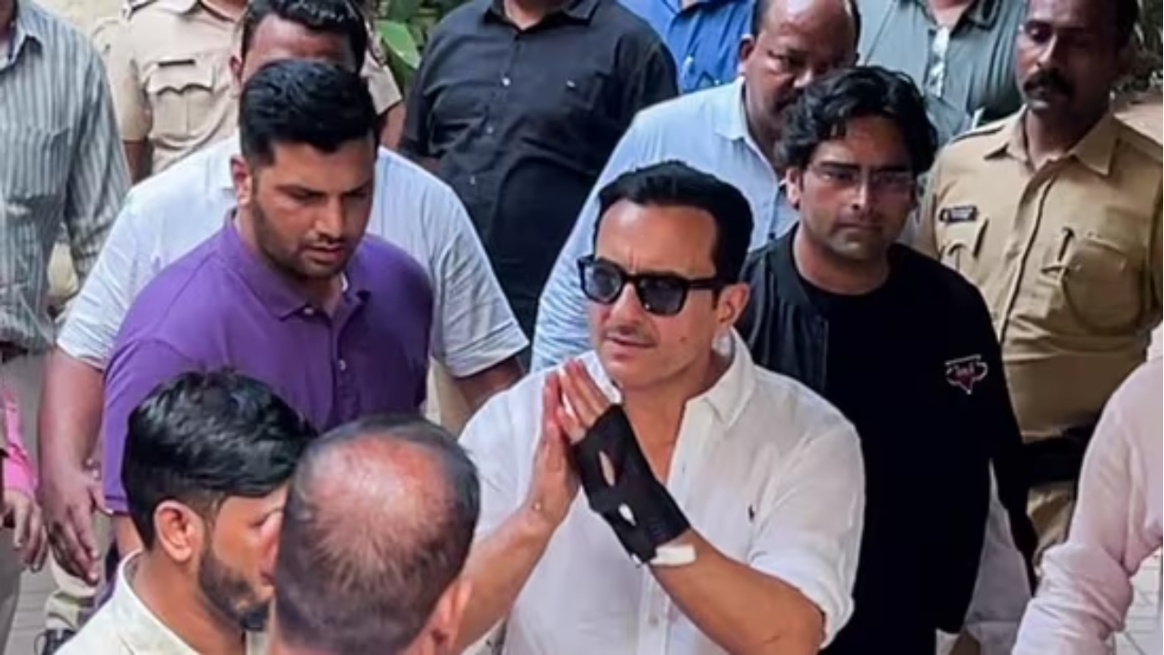 Actor Saif Ali Khan greets as he arrives at his residence after getting discharged from Lilavati Hospital,