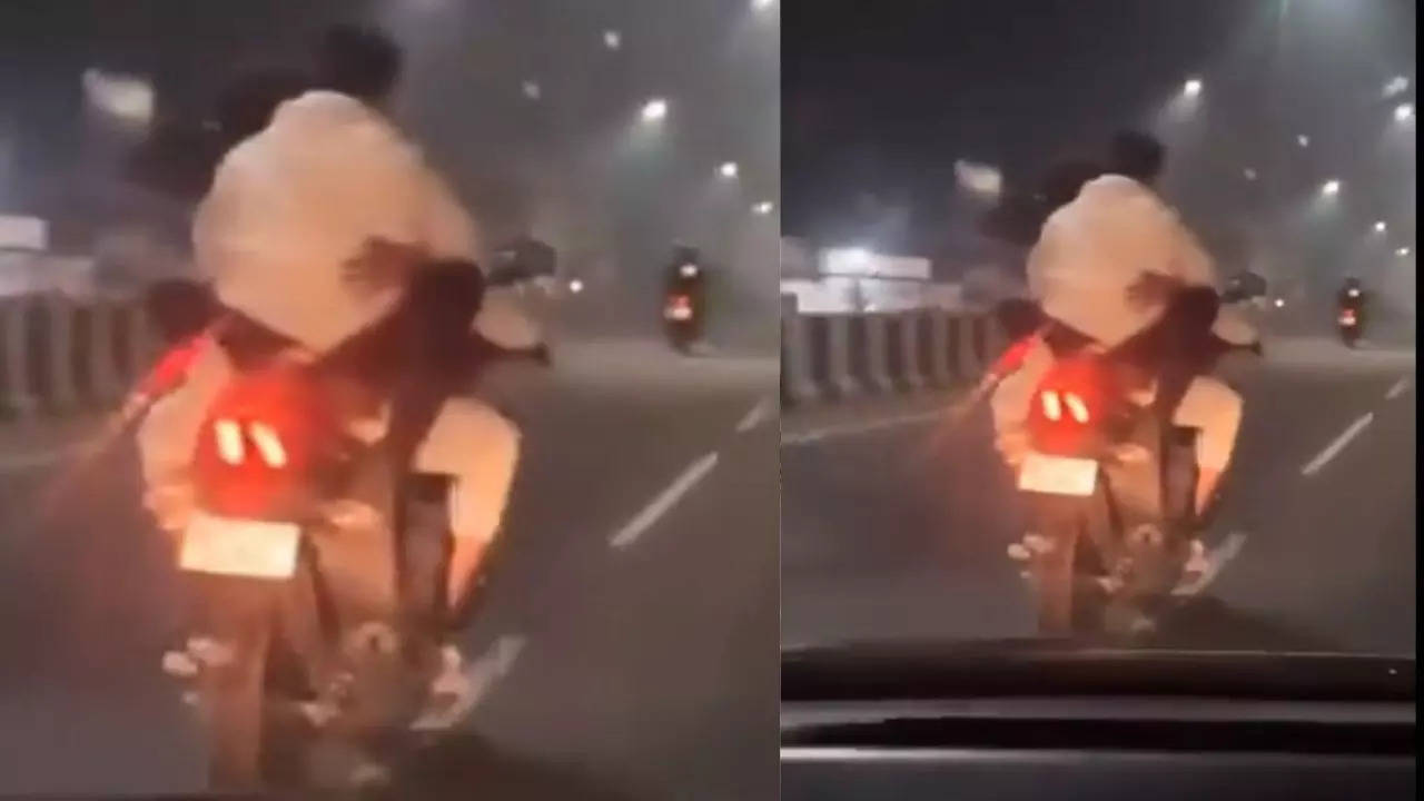 uttar pradesh  viral video a couple made intimate scenes on running bike at busiest uttar pradesh highway video gone viral 