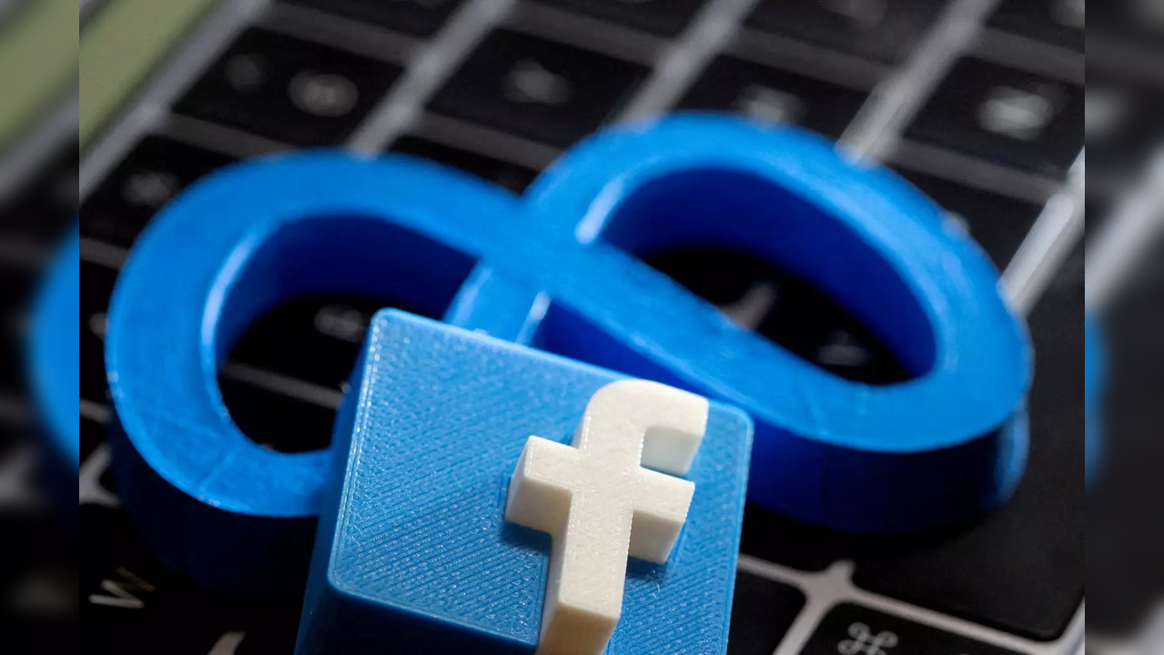 FILE PHOTO: A 3D-printed logo of Facebook sits atop logo of Facebook parent Meta in this photo illustration