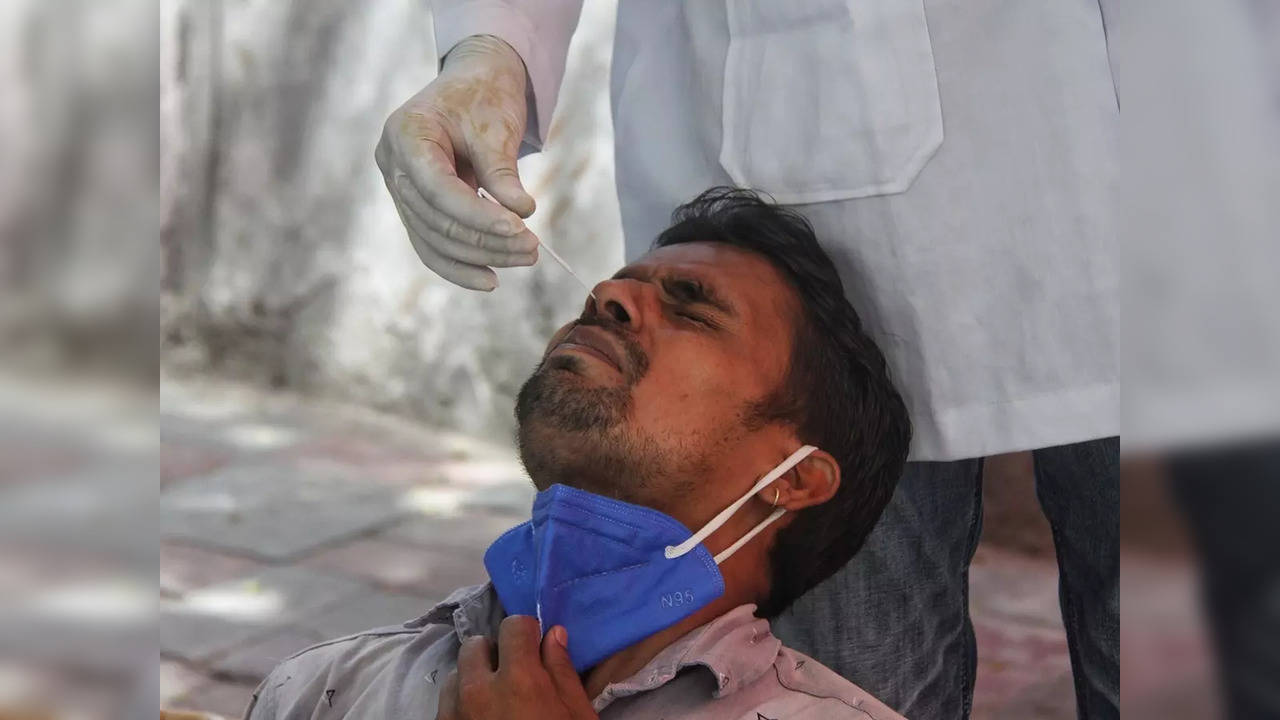 Health worker collect swab sample for COVID-19 testing at a centre in New Delhi