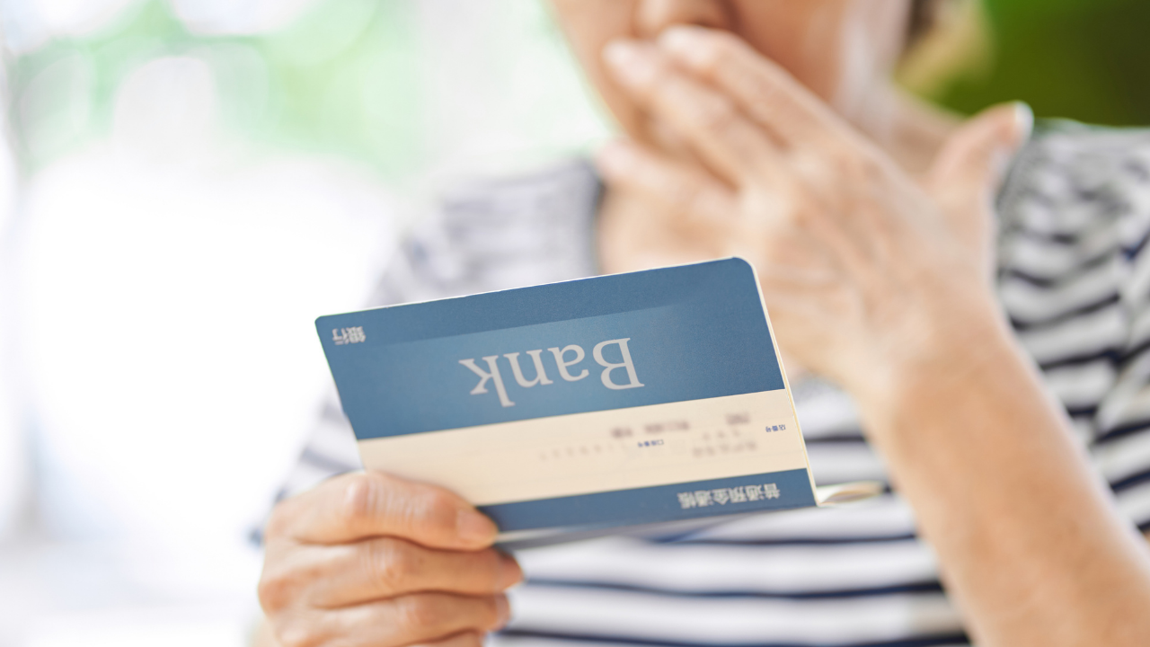 Woman checks bank account after 60 years