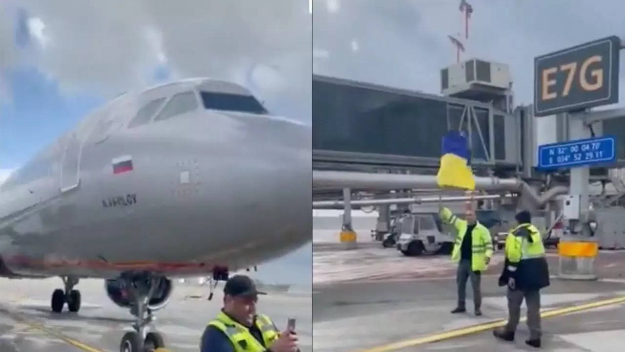 Airport worker waves Ukrainian flag at Russian plane. | Image courtesy: Reddit