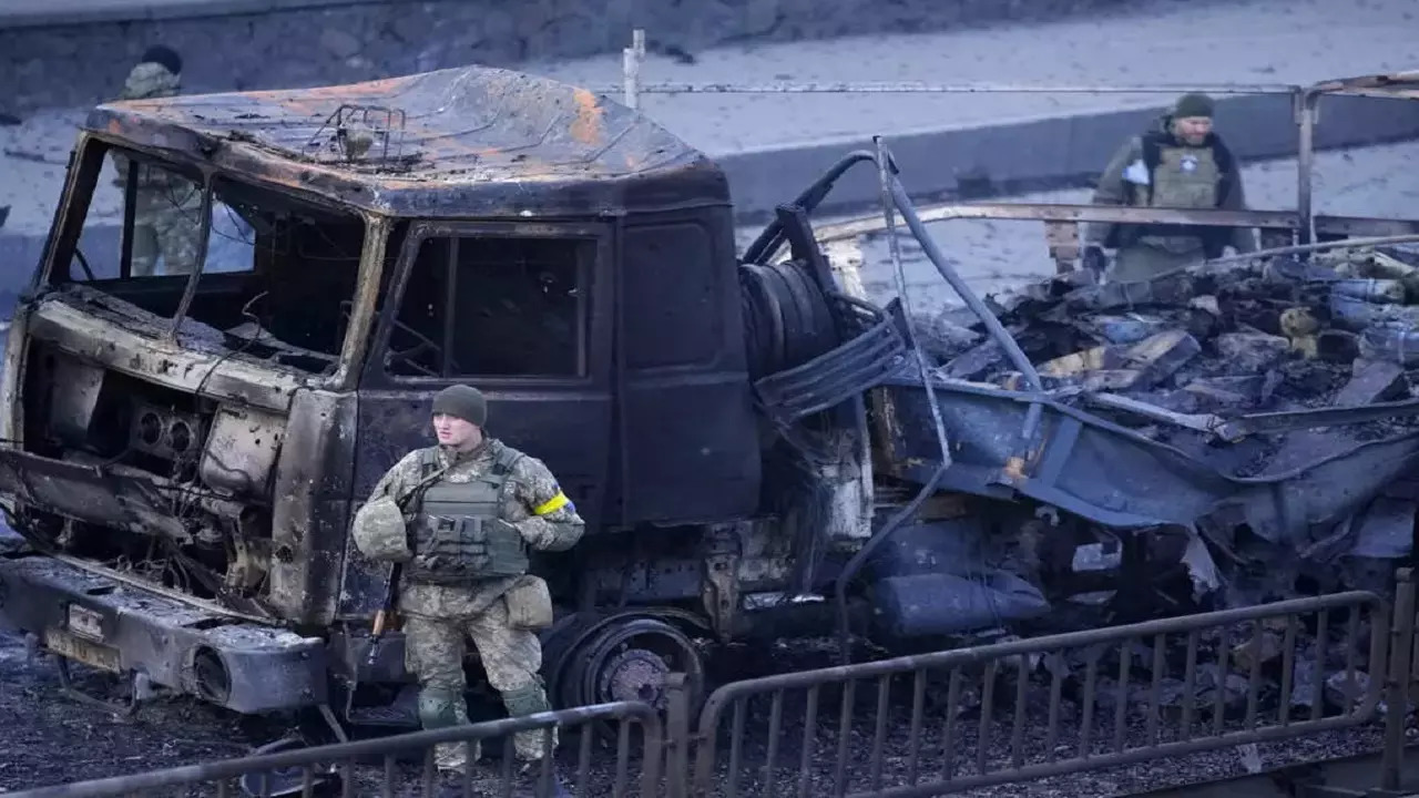 Ukrainian troops inspect the site of Russian airstrike in Kyiv