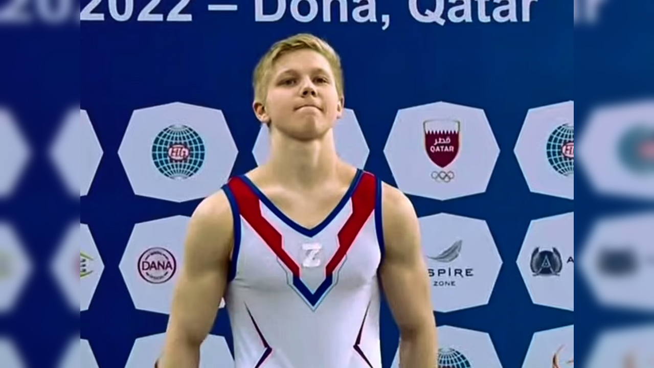 Russian gymnast stands on the podium with symbol supporting