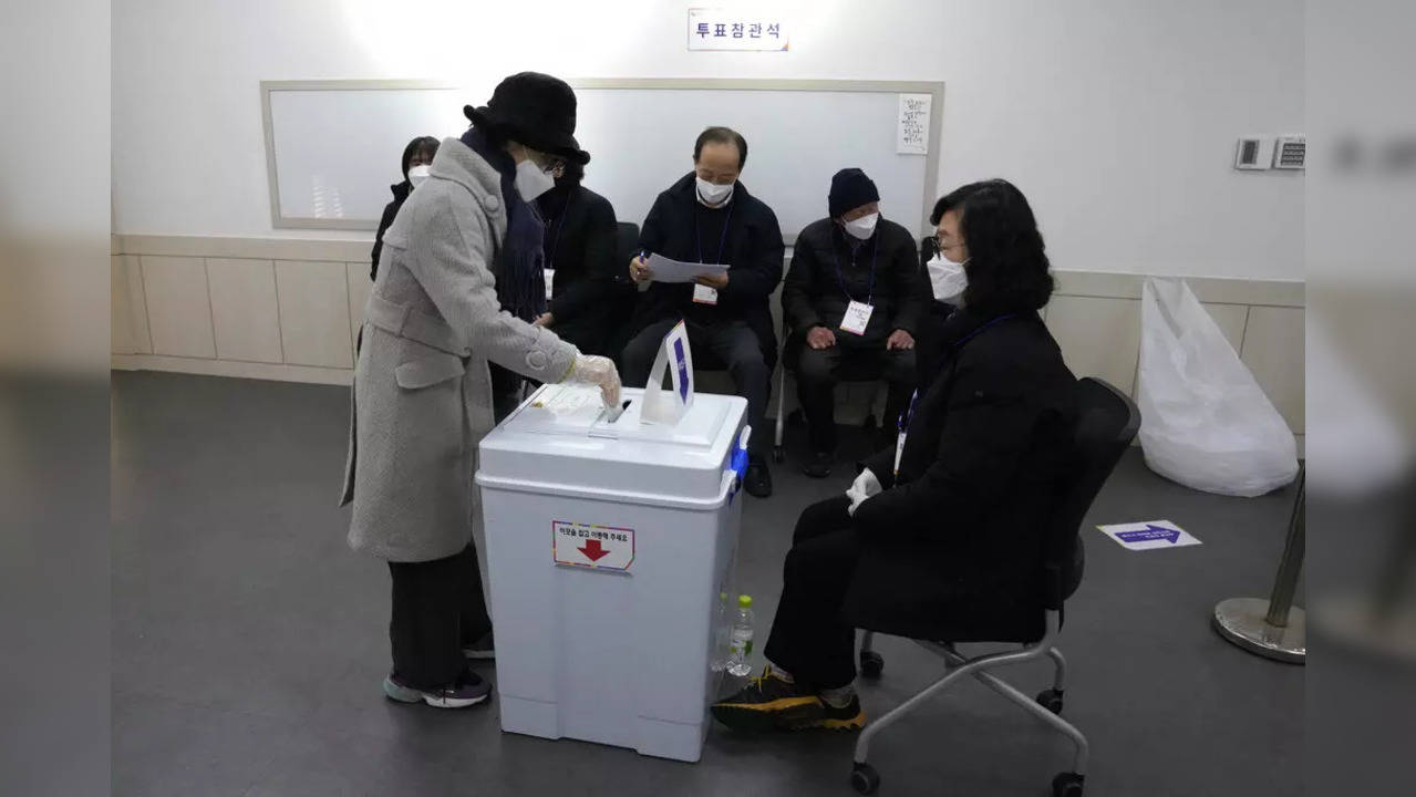 A voter casts a ballot for the presidential election at a local polling station in Seoul