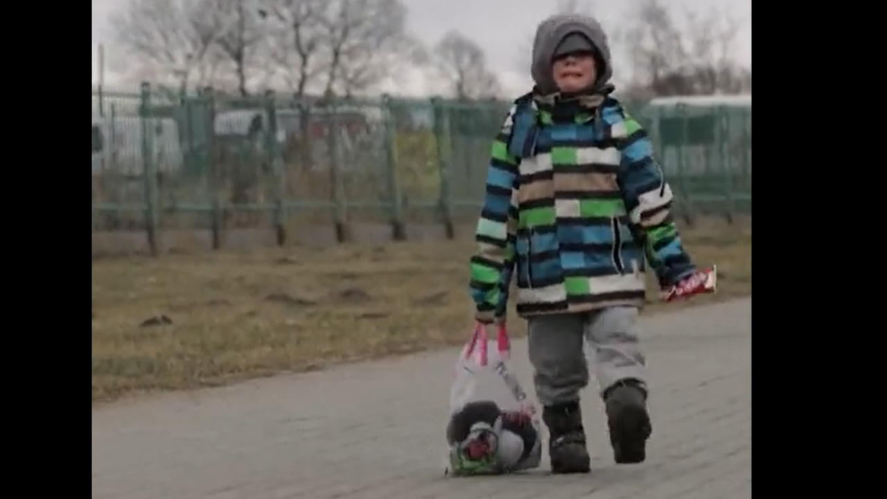 Ukraine boy cries while walking to Poland border