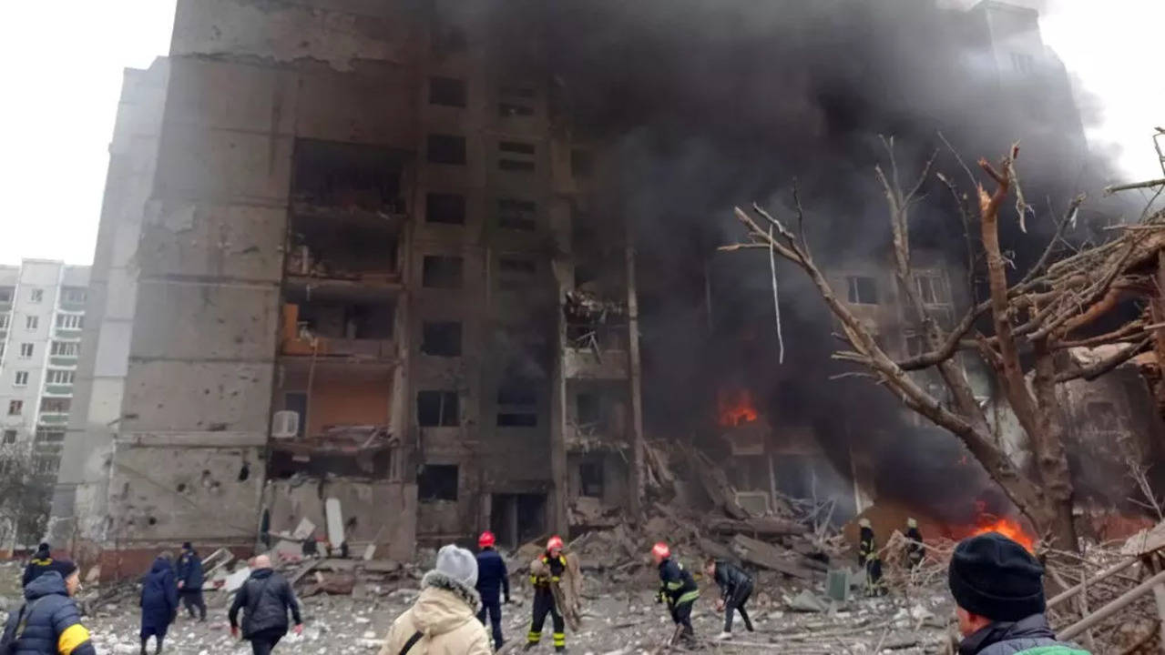 Firefighters work to extinguish a fire at a damaged city center after a Russian air raid in Chernigiv