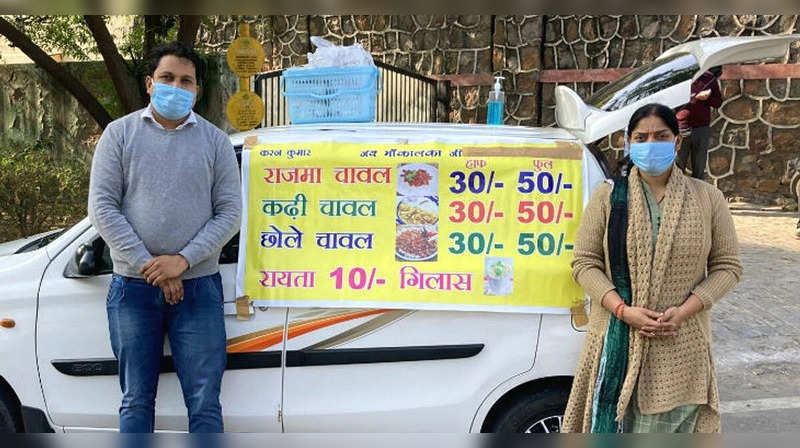 Amrita pictured with Karan next to their food vehicle | Image courtesy: The Better India