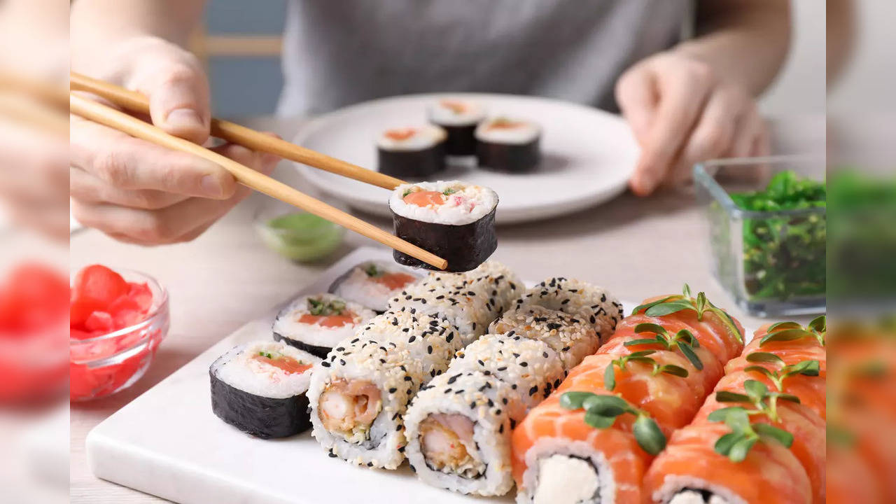 Woman eating sushi salmon fish