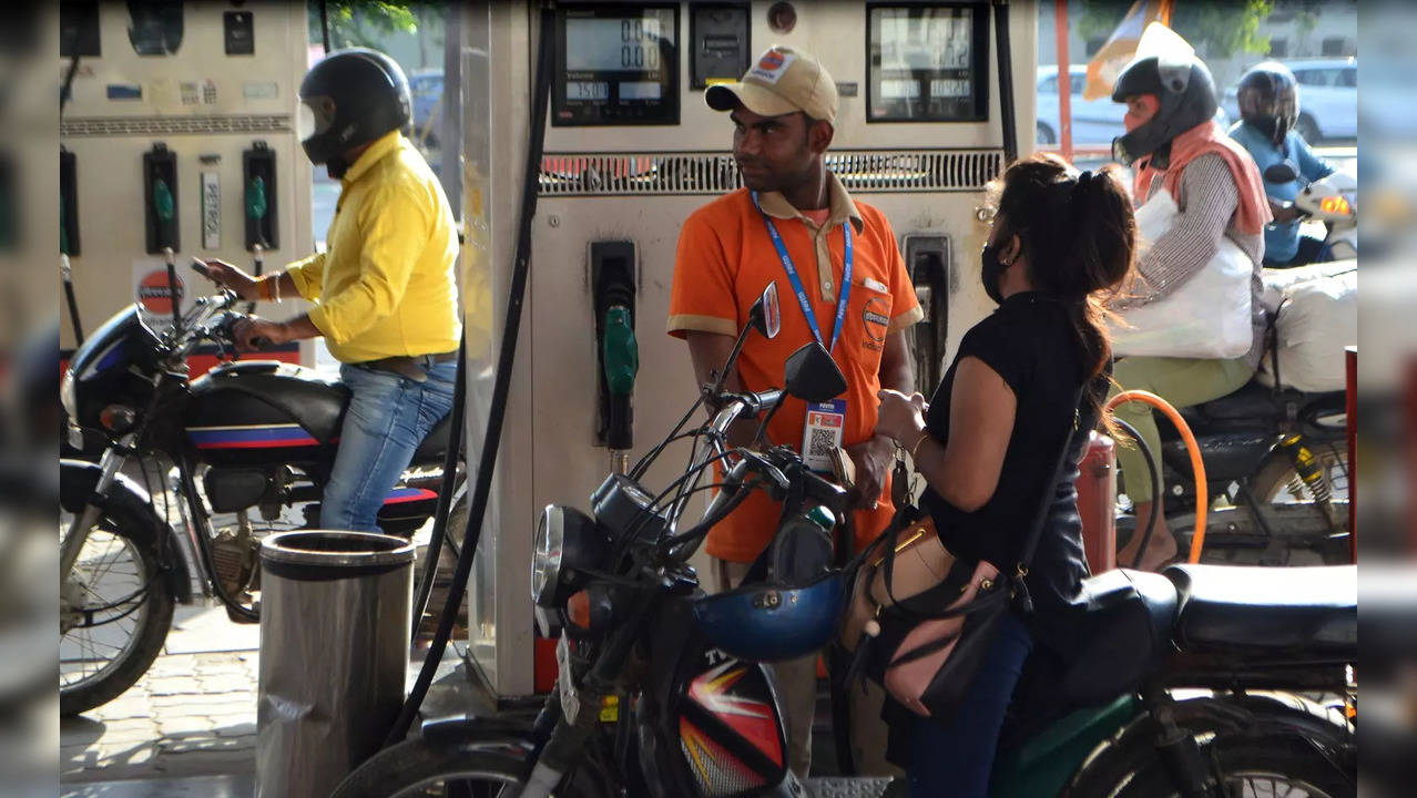 Gurugram: A pump attendant fills petrol at a fuel station, after another surge i...