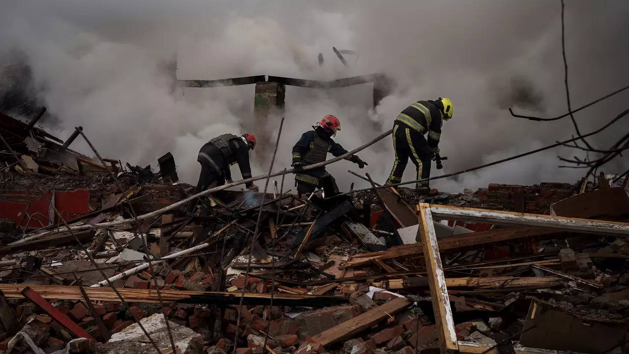 Firefighters work to extinguish a fire after a Russian attack destroyed the building of a Culinary School in Kharkiv