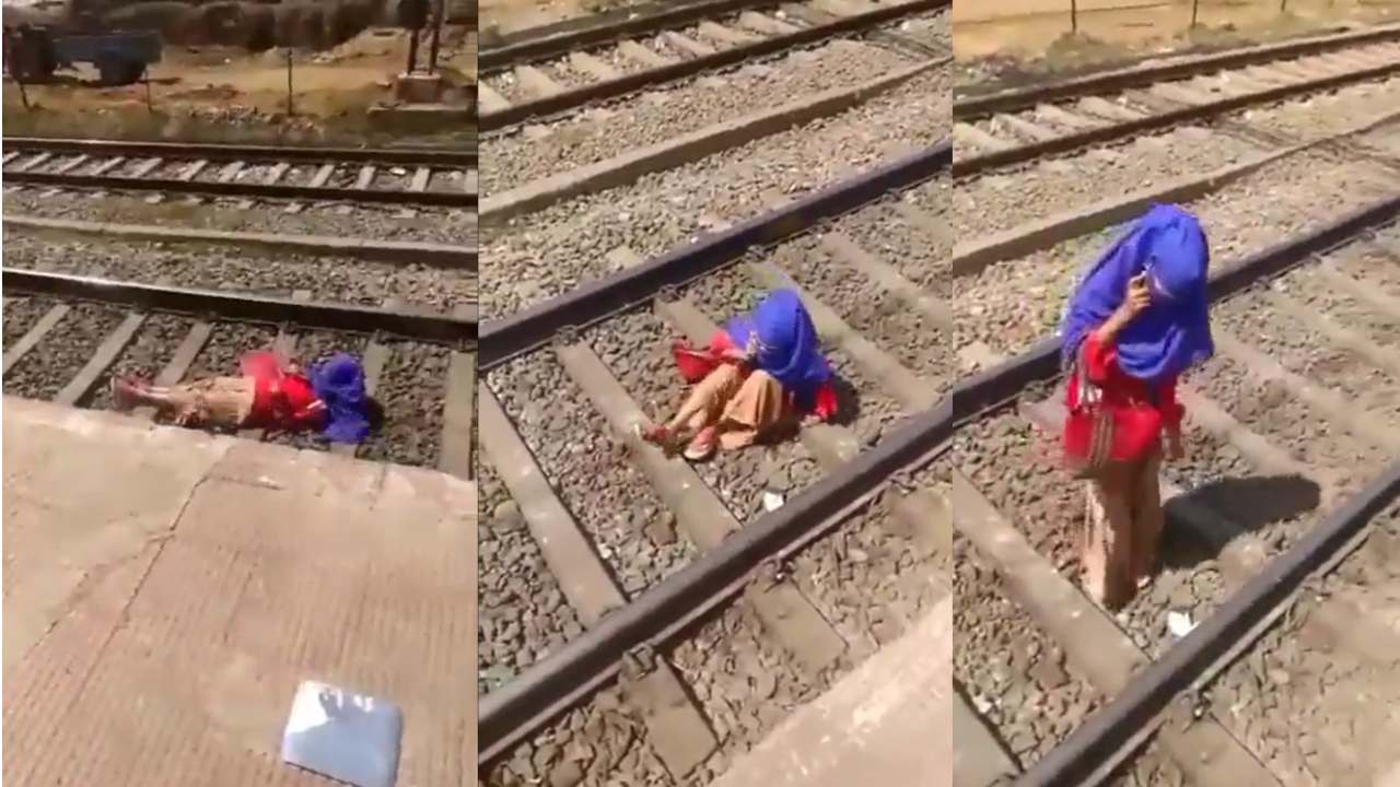 Woman lies on railway tracks as train runs over her, then gets up to take a phone call