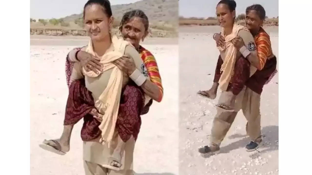 woman constable carried elderly woman on shoulders